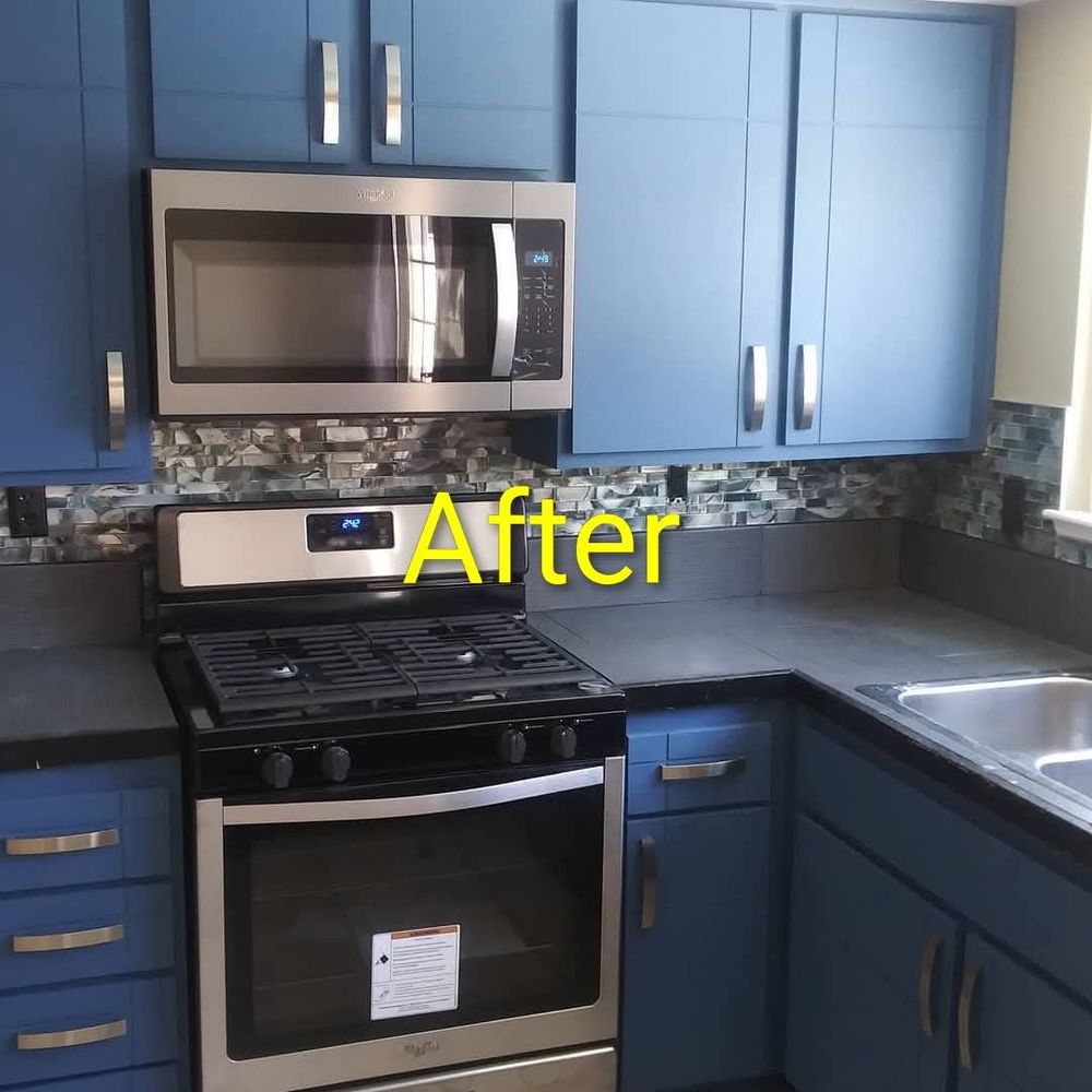 Kitchen after — painted blue cabinets, glass tile backsplash, LED lighting